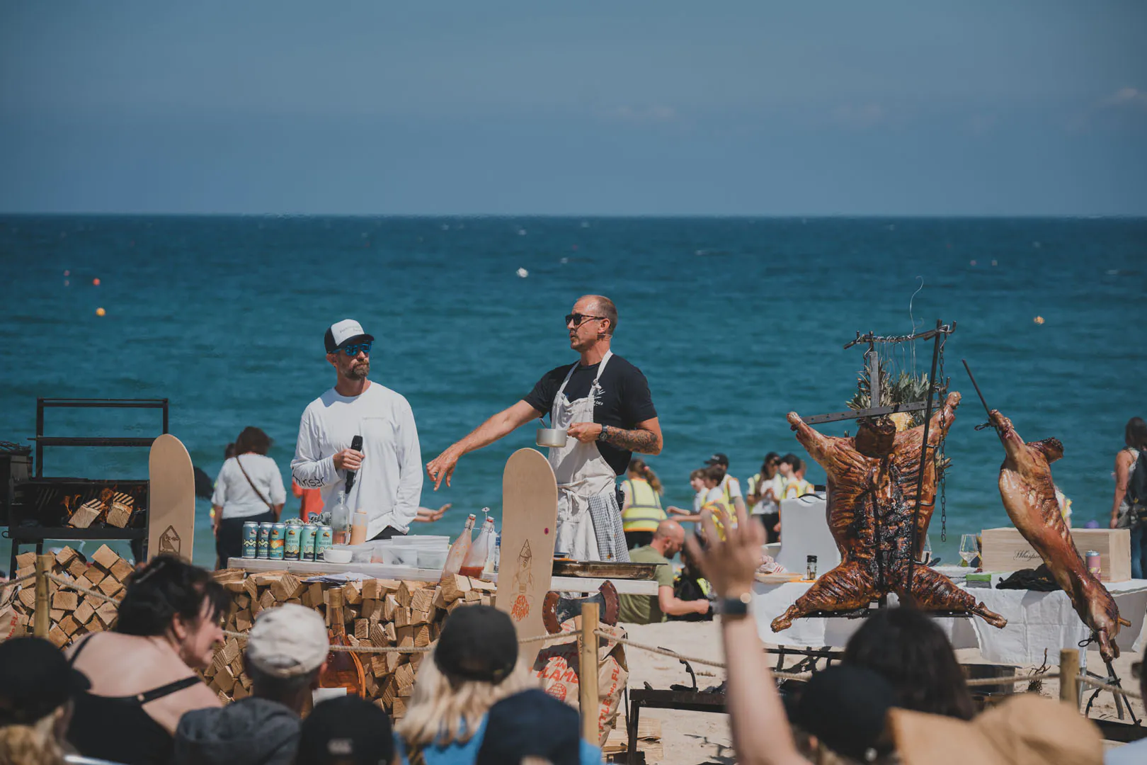 A man stands by a grill on the beach during the St Ives Food Festival cooking demonstration.