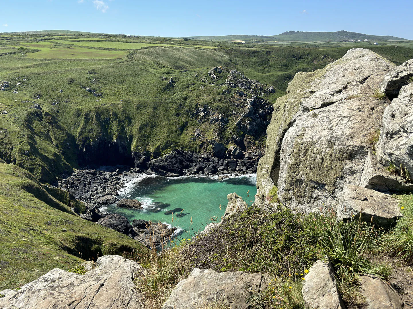 Rocky terrain with a small pond, showcasing the scenic beauty of Zennor Headland along the Salt Path Walk in Cornwall.