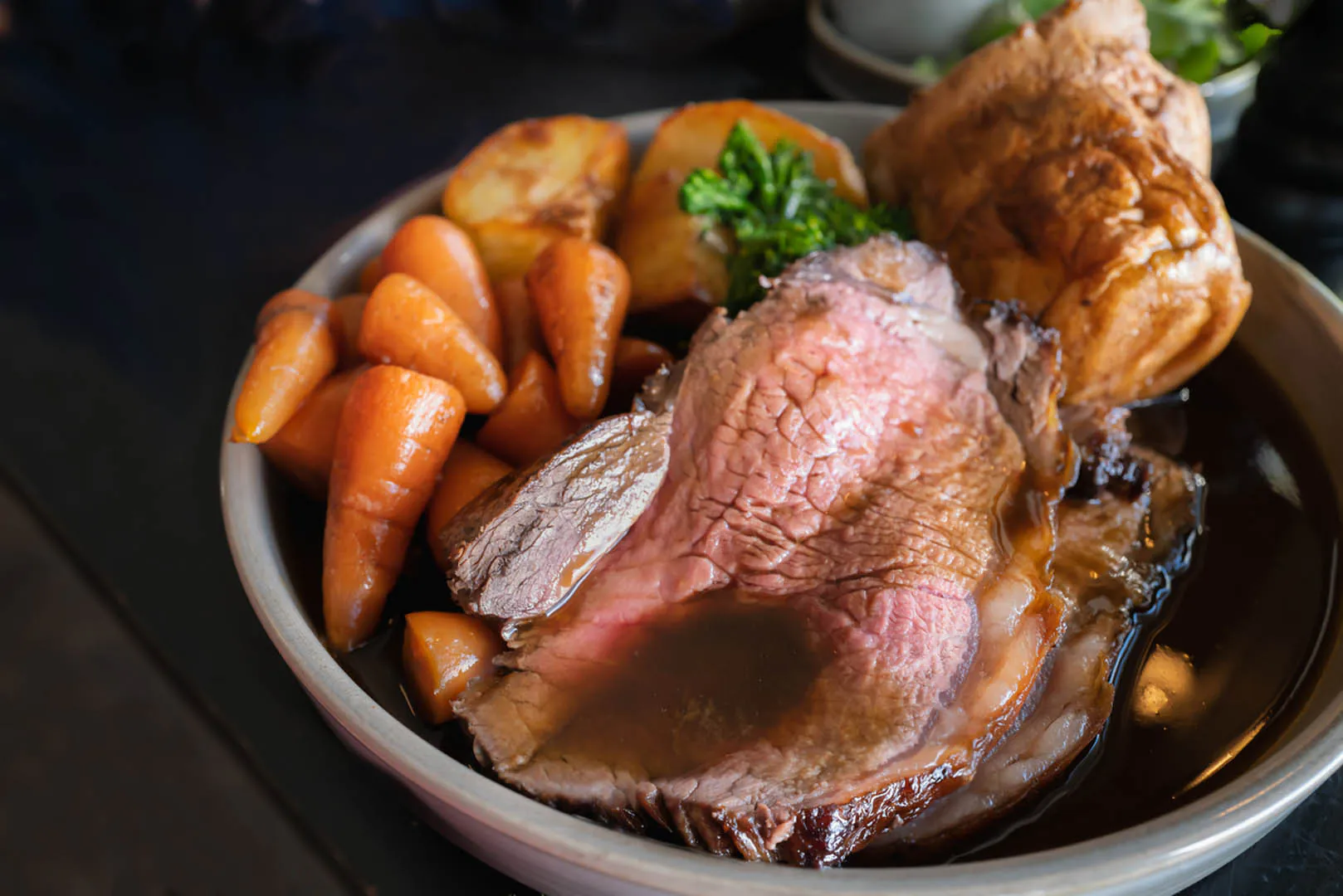 A hearty bowl of roast meat and vegetables smothered in rich gravy in a St Ives restaurant, perfect to indulge in after a walk.
